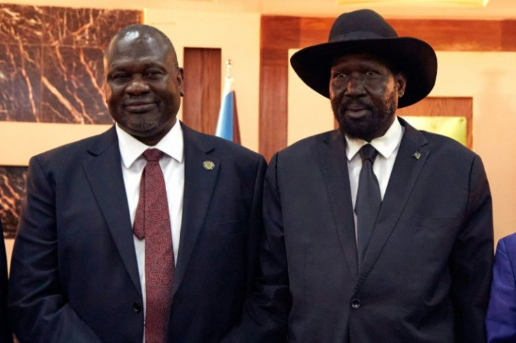 South Sudanese President Salva Kiir (R) stands with First Vice President Riek Machar on February 22, 2020 as they attend a swearing-in ceremony at the State House in Juba, South Sudan