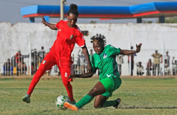 Sudan's Bakhita Kabros (L) vies for the ball against South Sudan's Amadrio Filda Amosu Bandas (R) during a match -- the inexperienced Sudan side has yet to win on the field but victory has come in other ways