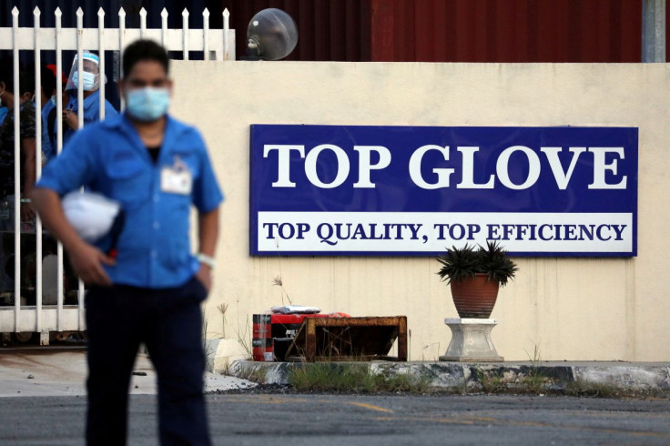 A worker leaves a Top Glove factory after his shift in Klang, Malaysia December 7, 2020.
