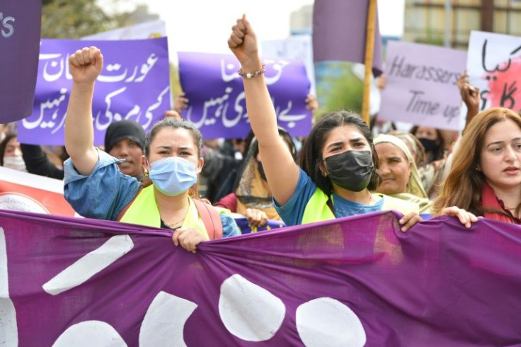 Aurat March protesters hold placards and shout slogans as they gather to mark International Women's Day in Islamabad