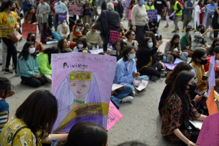 Aurat March protesters hold placards as they gather to mark the International Women's Day in Islamabad