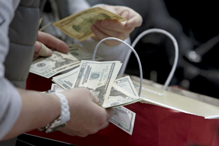 People count money at Macy's Herald Square store during the early opening of the Black Friday sales in the Manhattan borough of New York, November 26, 2015. 