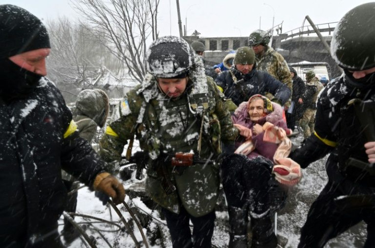 Despite the sound of nearby shelling in Irpin, seen as a critical point for Russia's advance on Kyiv, civilians continued to flee in icy wind and a thick snowfall