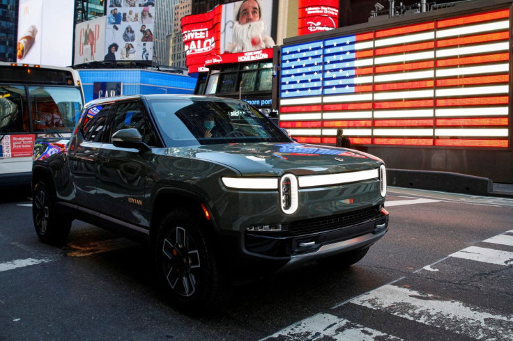 A Rivian R1T pickup, the Amazon-backed electric vehicle (EV) maker, is driven through Times Square during the companyâs IPO in New York City, U.S., November 10, 2021. 