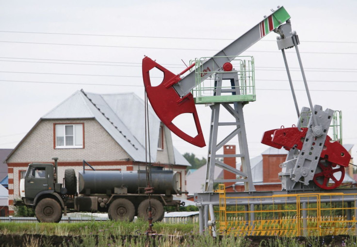 A fuel tanker truck drives past a pump jack at an oil field Sergeyevskoye owned by Bashneft company north from Ufa, Bashkortostan, Russia, July 11, 2015. 