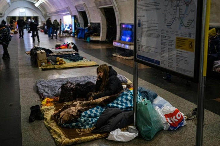 People spread out on the benches and hallways of the metro station
