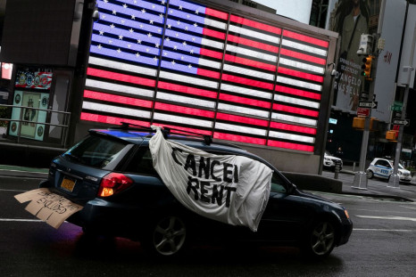 A sign is displayed on a car in Times Square during a demonstration calling for workers' rights and cancelling of rent payment as the spread of the coronavirus disease (COVID-19) continues in New York City, New York, U.S., May 1, 2020. 