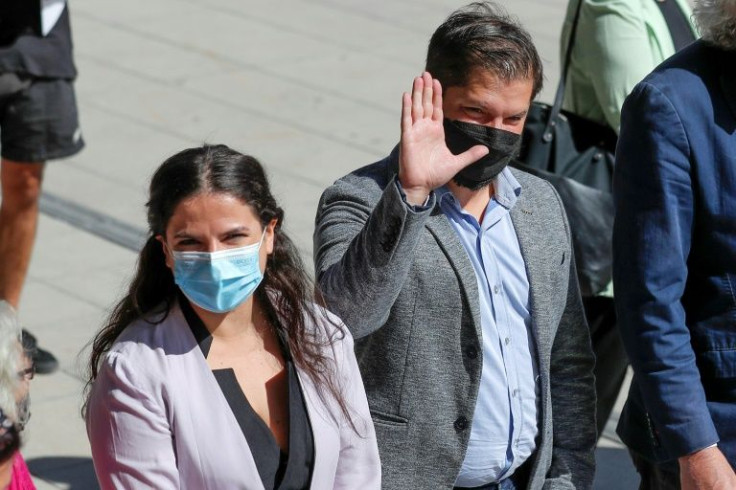 Chilean president-elect Gabriel Boric (R) and his minister of women appointee Antonia Orellana attend an event on International Women's Day in Santiago on March 8, 2022