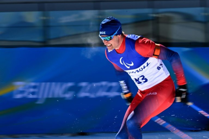 Norwayâs Nils Erik Ulset races towards the finish line at the menâs sprint standing biathlon event in Beijing