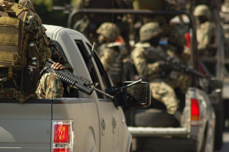 Soldiers ride on trucks while patrolling the streets of Morelia December 14, 2010. Mexico&#039;s spiraling war against powerful drug cartels escalated this week and clashes caused war-like scenes of burned-out and bullet-riddled cars around Michoacan&#039