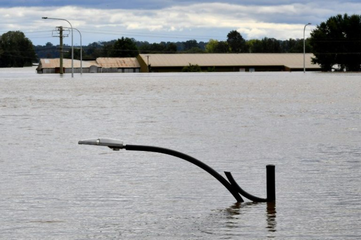 A lamp post is seen submerged in the floodwaters