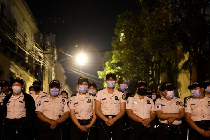Police officers stand guard outside the Guatemalan Congress on March 8