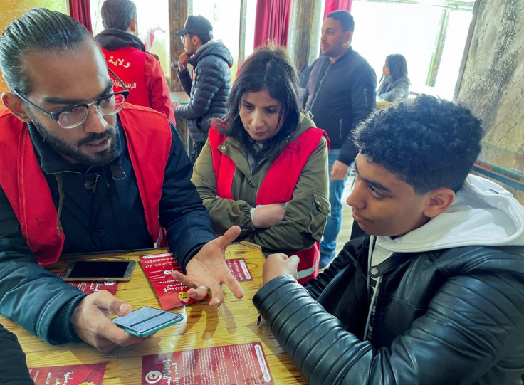 Ahmed Kouki, a pro-Saied volunteer, introduces to students an online multiple-choice questionnaire that President Kais Saied has set up as a part of a 'consultation' before he rewrites the constitution, in Tunis, Tunisia February 28, 2022. Picture taken F