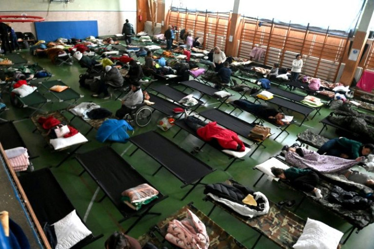 Ukrainians shelter in a temporary refugee centre at a primary school across the border in Zahony, Hungary