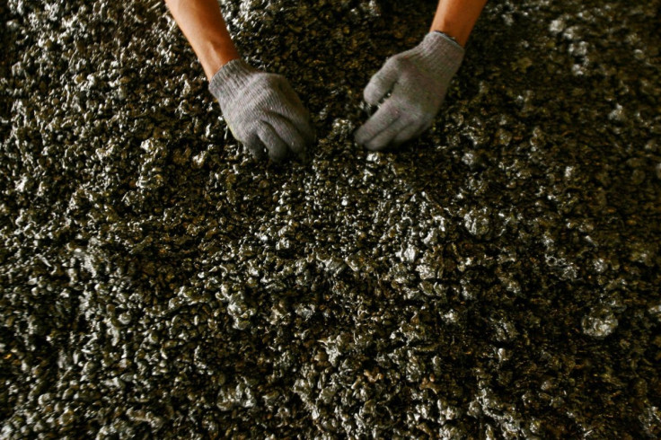 A worker displays nickel ore in a ferronickel smelter owned by state miner Aneka Tambang Tbk at Pomala district, Indonesia, March 30, 2011.