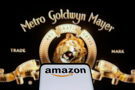 Smartphone with Amazon logo is seen in front of displayed MGM logo in this illustration taken, May 26, 2021. 
