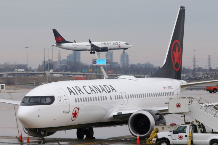 An Air Canada Boeing 737 MAX 8 from San Francisco approaches for landing at Toronto Pearson International Airport over a parked Air Canada Boeing 737 MAX 8 aircraft in Toronto, Ontario, Canada, March 13, 2019.