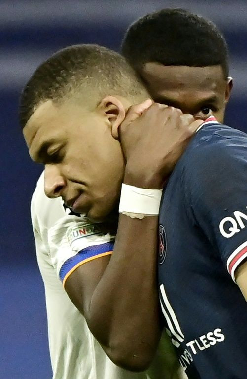 All over: Real Madrid's Austrian defender David Alaba comforts Paris Saint-Germain's French forward Kylian Mbappe