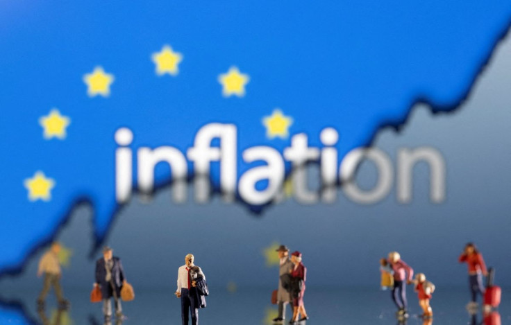 Small figurines are seen in front of displayed word "Inflation", EU flag and rising stock graph in this illustration taken February 11, 2022. 