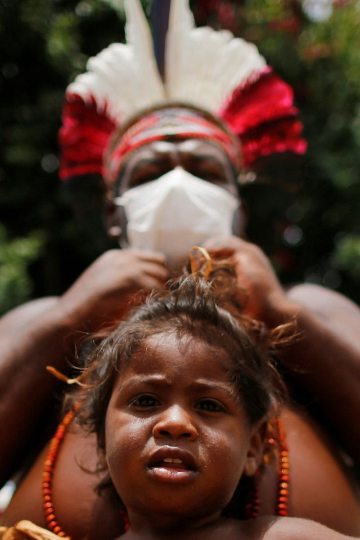 A Pataxo child looks on during a protest against President Bolsonaro's policies that undermine their land rights next to the National Congress, in Brasilia, Brazil March 8, 2022.