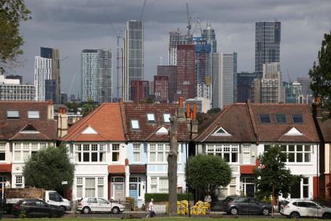 High-rise apartments under construction can be seen in the distance behind a row of residential housing in south London, Britain, August 6, 2021. 