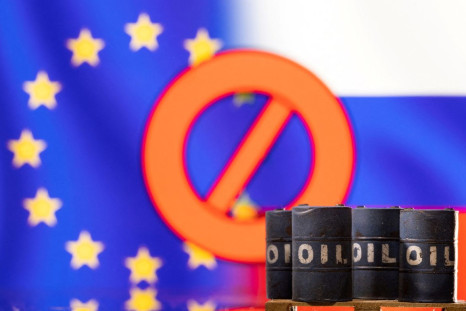 Models of oil barrels are seen in front of the displayed sign "stop", EU and Russia flag colours in this illustration taken March 8, 2022. 
