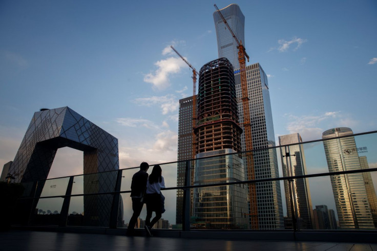 People look at the skyline of the Central Business District in Beijing, China,  April 16, 2020.  