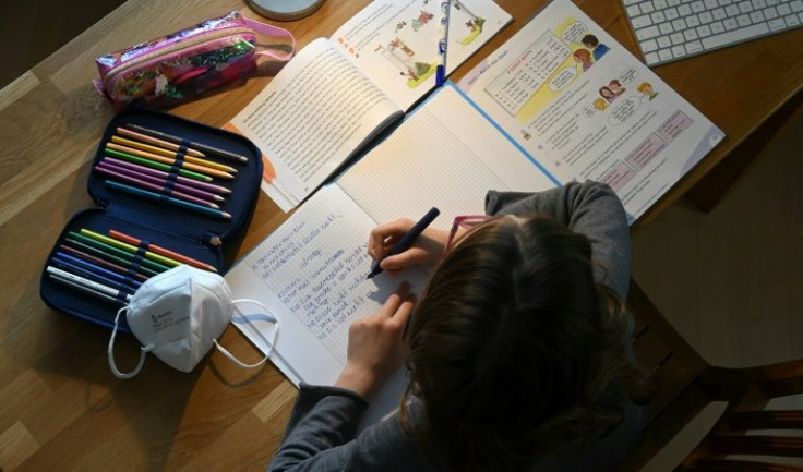 A young girl completes her homework in Munich, Germany