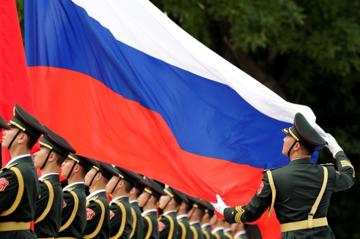 An honour guard holds a Russia flag during preparations for a welcome ceremony for Russian President Vladimir Putin outside the Great Hall of the People in Beijing, China June 8, 2018. 