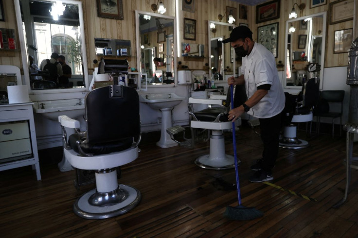A hairdresser sweeps the floor of a hairdressing salon in 'Yungay' neighbourhood, where Chile's incoming President Gabriel Boric will move to his new residence in Santiago, Chile March 8, 2022. Picture taken March 8, 2022.