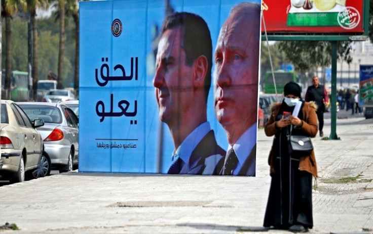 A banner depicting Syrian President Bashar al-Assad and Russian President Vladimir Putin and reading "Justice Prevails", is displayed along a highway in the Syrian capital Damascus, on March 8, 2022