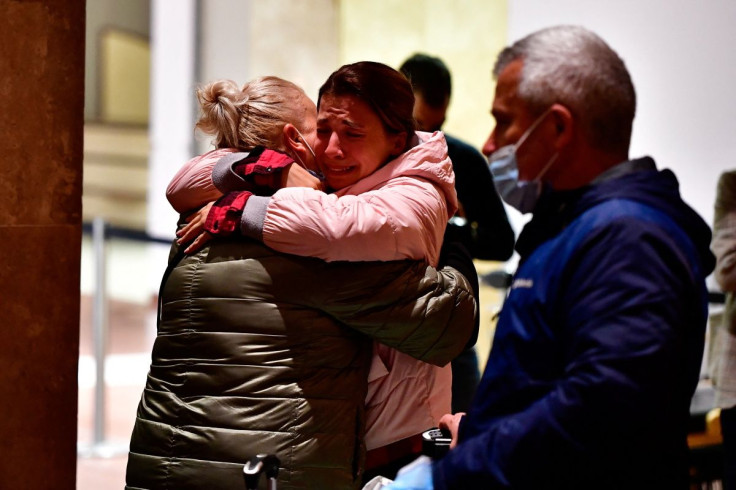 Members of a Ukrainian family embrace each other, after arriving from Egypt where they were on holiday when Russia's invasion of Ukraine started, at the Ferenc Liszt airport's terminal 1 in Budapest, Hungary, March 9, 2022.