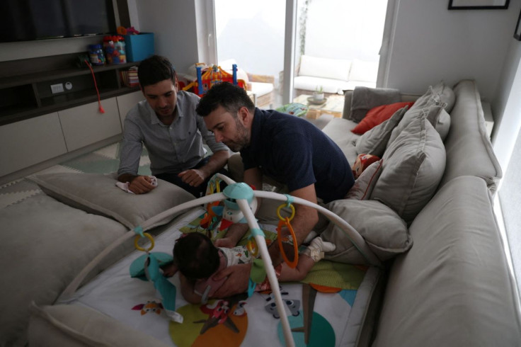 Chilean couple Javier Silva and Jaime Nazar prepare their daughter to take a nap, a day before their wedding, as the same-sex marriage law goes into effect, in Santiago, Chile March 9, 2022. Picture taken March 9, 2022. 