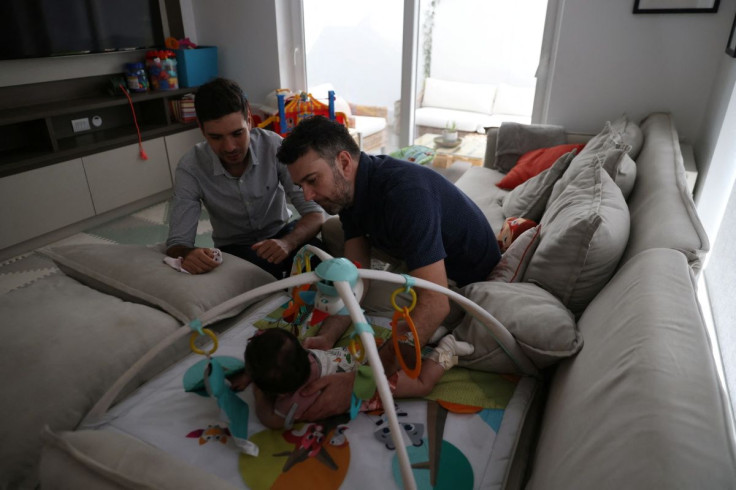 Chilean couple Javier Silva and Jaime Nazar prepare their daughter to take a nap, a day before their wedding, as the same-sex marriage law goes into effect, in Santiago, Chile March 9, 2022. Picture taken March 9, 2022.