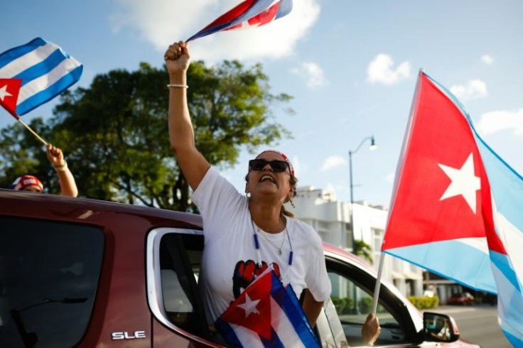 A woman holds a Cuban flag during a protest showing support for Cubans demonstrating against their government, at Versailles Restaurant in Miami, on July 18, 2021
