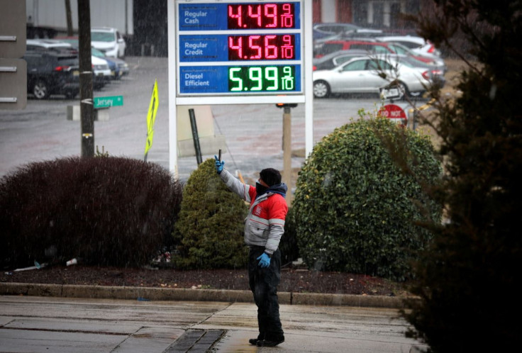 A worker takes pictures of gasoline prices at a gas station, following Russia's invasion of Ukraine, in Jersey City, New Jersey, U.S., March 9, 2022. 