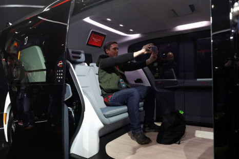 An attendee takes a selfie inside a Cruise Origin autonomous vehicle, a Honda and General Motors self-driving car partnership, during its unveiling in San Francisco, California, U.S. January 21, 2020. 
