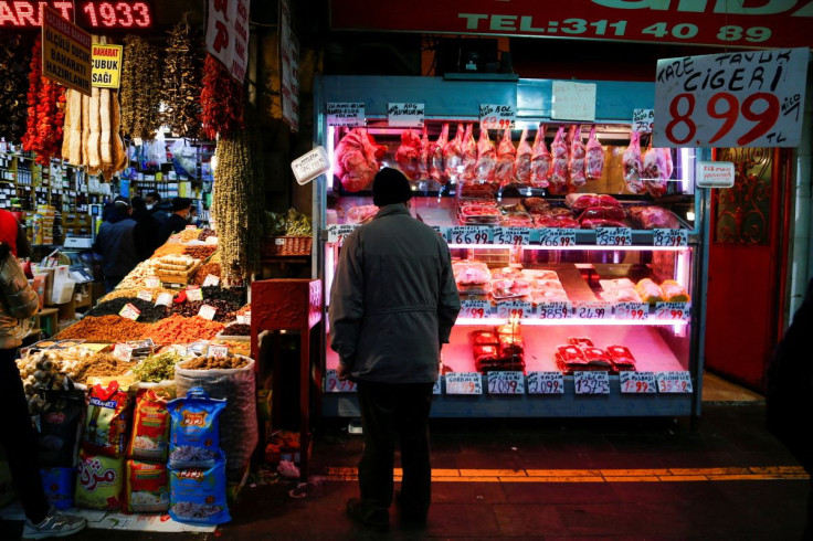 A man looks at a butcher shop window in Ankara, Turkey February 16, 2022. 