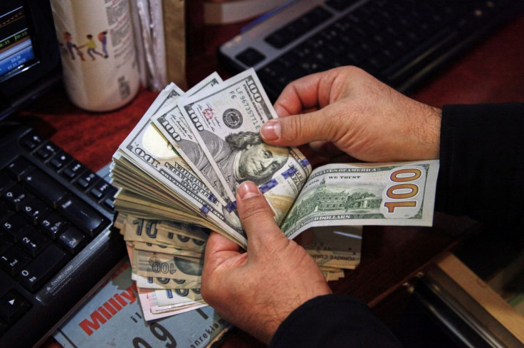 A money changer counts U.S. dollar banknotes at a currency exchange office in Ankara, Turkey November 11, 2021. 