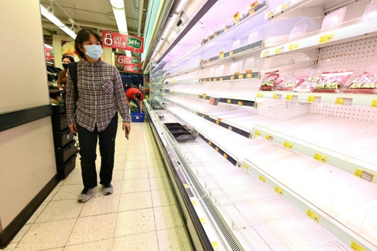 Refugees in Hong Kong are required to use government e-tokens at supermarkets, where shelves are bare and prices are soaring
