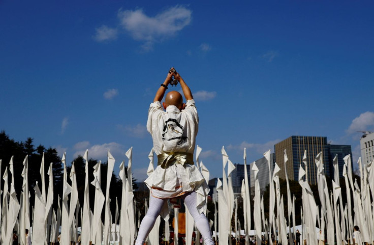A man performs to mourn the victims of the March 11, 2011 earthquake and tsunami at a gathering to pay a silent tribute on the 11th anniversary of the events that killed thousands and set off a nuclear crisis, in Tokyo, Japan March 11, 2022.