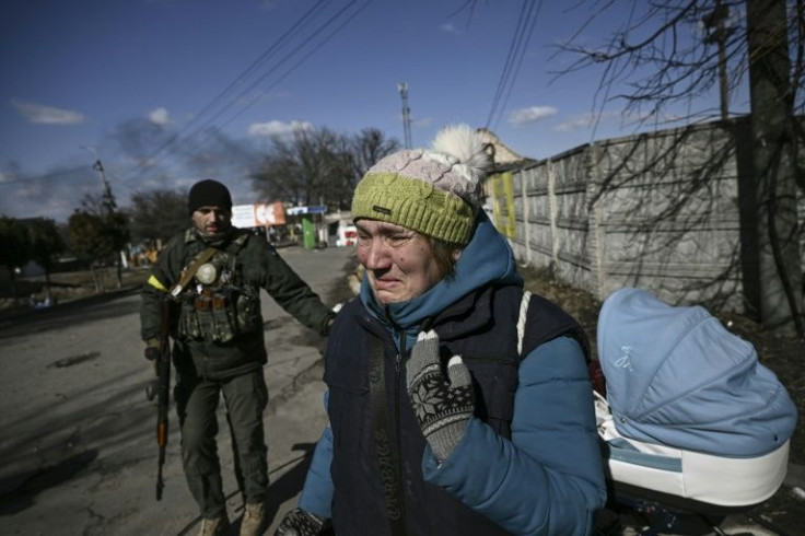 A woman cries as she is evacuated from Irpin, just north of Kyiv, as Russian tanks press closer