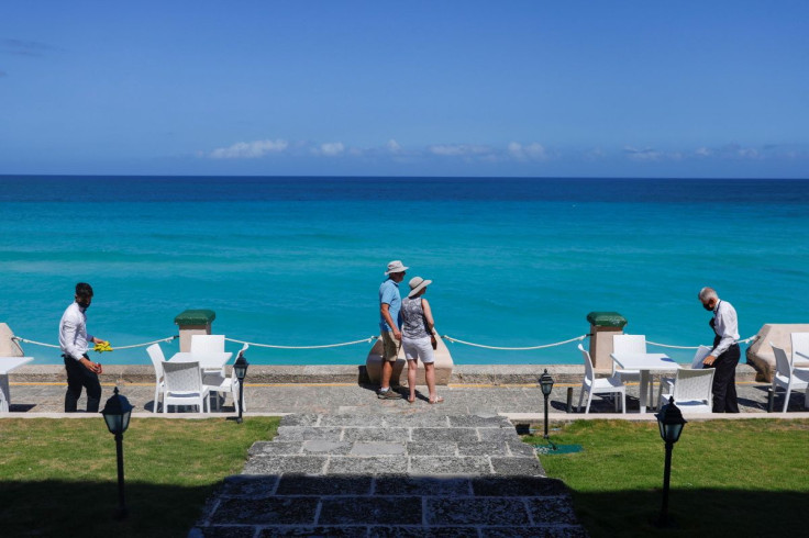 British tourists stand in a restaurant as employees arrange chairs near the sea in Varadero, Cuba, March 7, 2022. Picture taken March 7, 2022.
