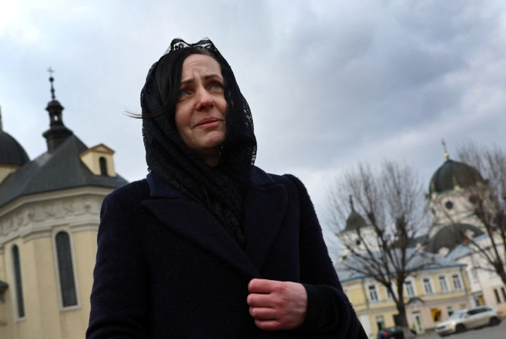 Oksana Dudar, widow of Victor, reacts as she talks about the killing of her husband who had volunteered for the territorial defence following the Russian invasion, during an interview with Reuters outside the local museum of Zhokava on the outskirts of Lv