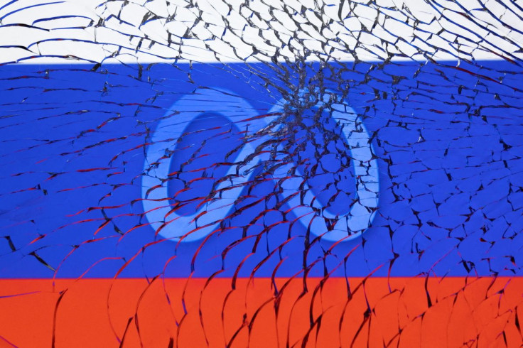 Meta logo and Russian flag are seen through broken glass in this illustration taken March 1, 2022. 