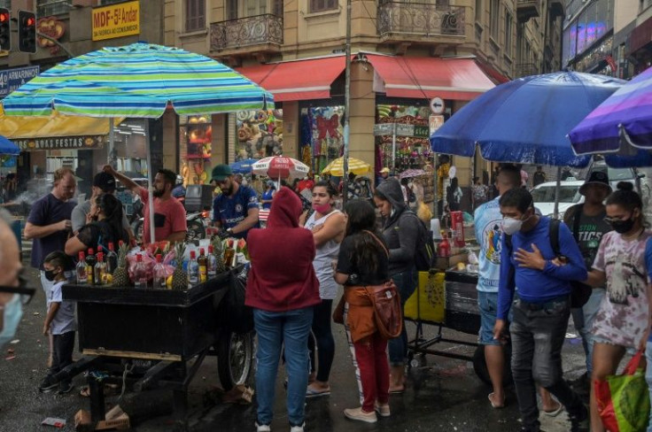 This file photo taken on December 30, 2021 shows people in a commercial street in downtown Sao Paulo, Brazil