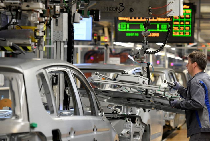 An employee moves car components in a production line at the Volkswagen plant in Wolfsburg, Germany March 1, 2019.