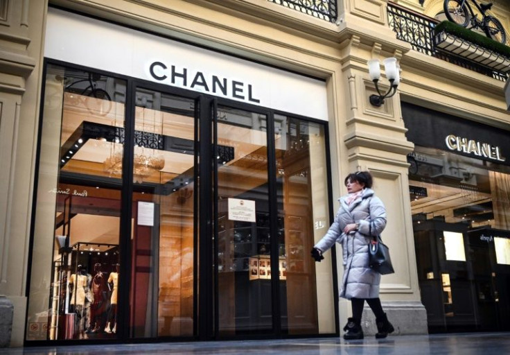 A woman walks past a closed Chanel shop in Moscow on Thursday. Many fashion and luxury brands have announced they will suspend operations in Russia even though the  sector was not included in Western sanctions.
