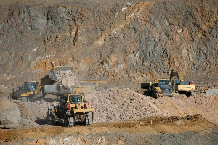 Wheel loaders fill trucks with ore at the MP Materials rare earth mine in Mountain Pass, California, U.S. January 30, 2020. 