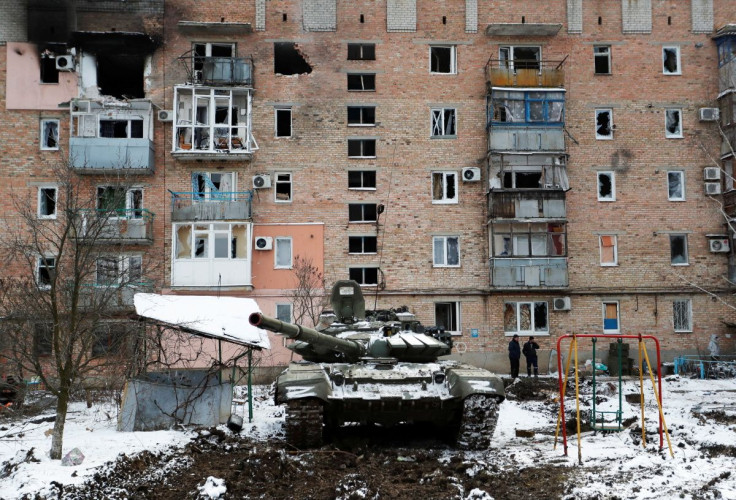 A tank with the letters "Z" painted on it is seen in front of a residential building which was damaged during Ukraine-Russia conflict in the separatist-controlled town of Volnovakha in the Donetsk region, Ukraine March 11, 2022. 